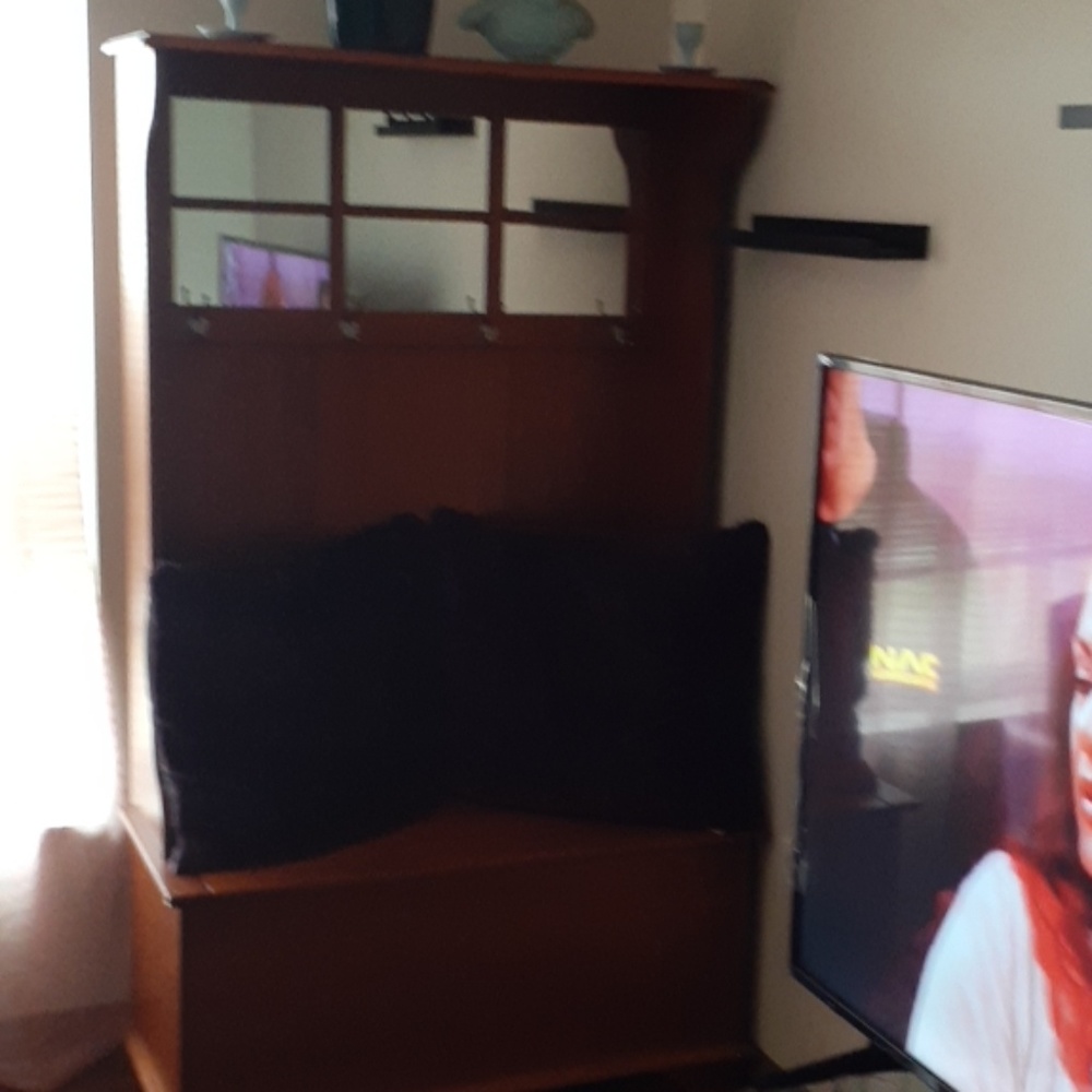 A shelf with a mirror a chess inside and coat hook